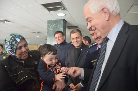 Canadian Immigration Minister John McCallum talks to Syrian refugees at the Amman civil airport in Marka on Sunday (Photo by Muath Freij)